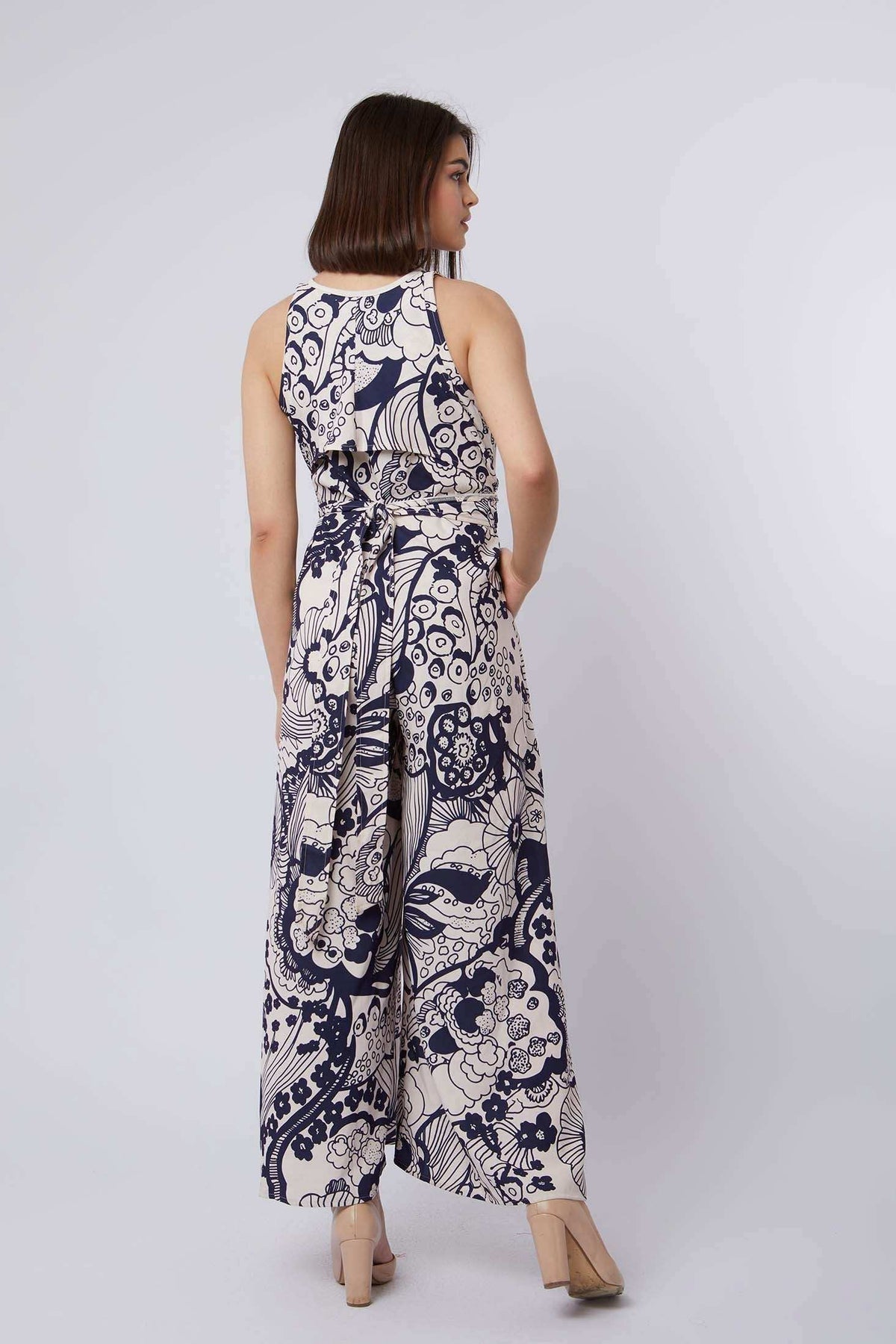Woman in Dalydress sleeveless floral print jumpsuit, back view, casual chic fashion