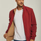 Man modeling casual red jacket with beige lining, white t-shirt, and blue jeans