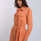 Woman wearing an orange belted shirt with front pockets, Dalydress women's fashion.