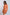 Woman wearing an orange belted shirt with front pockets, Dalydress women's fashion.