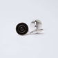 Silver round cufflinks with black concentric circle design on white background