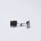 Square silver cufflinks with diagonal stripe pattern on a white background