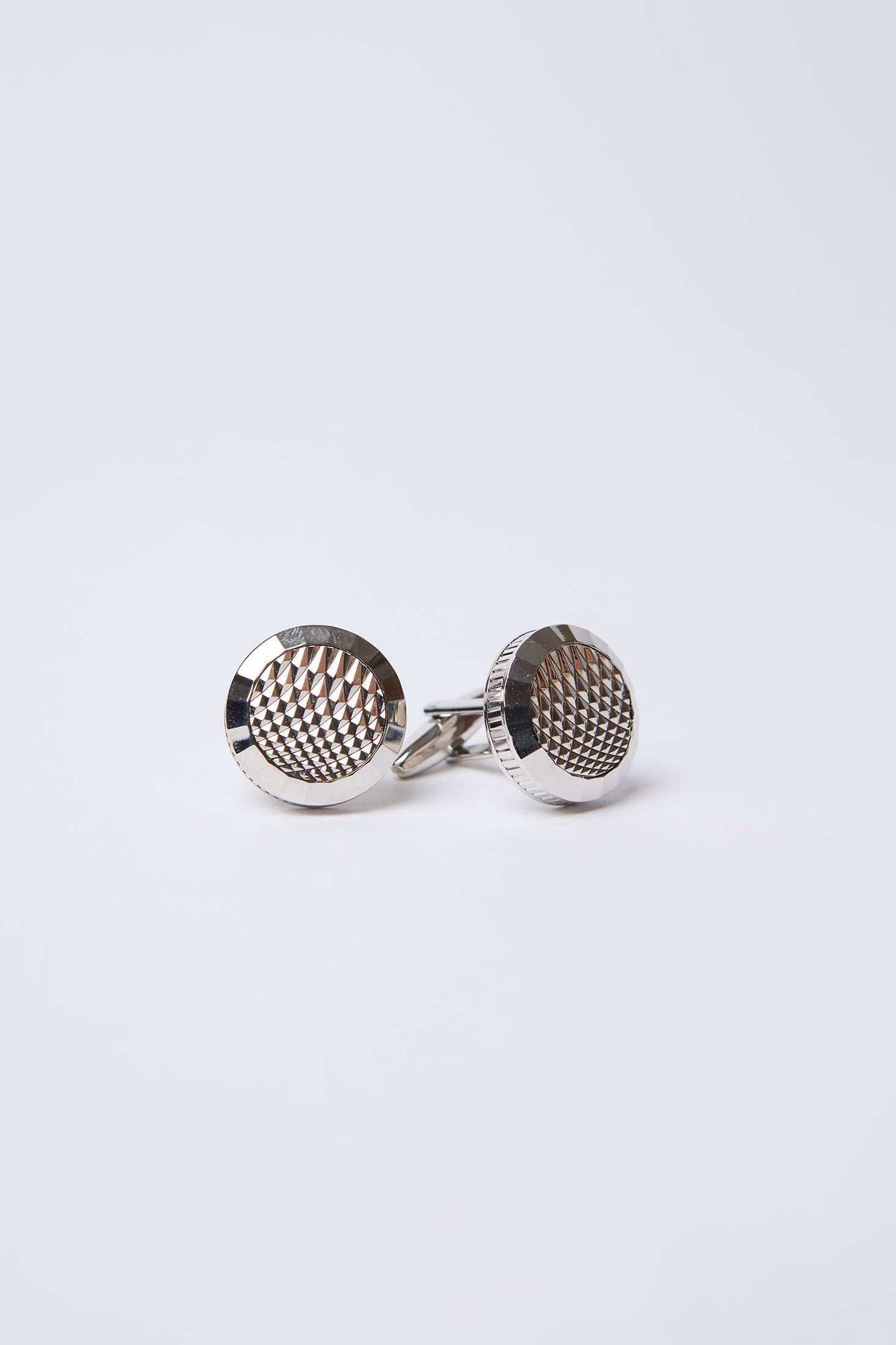 Silver round cufflinks with textured geometric pattern on white background