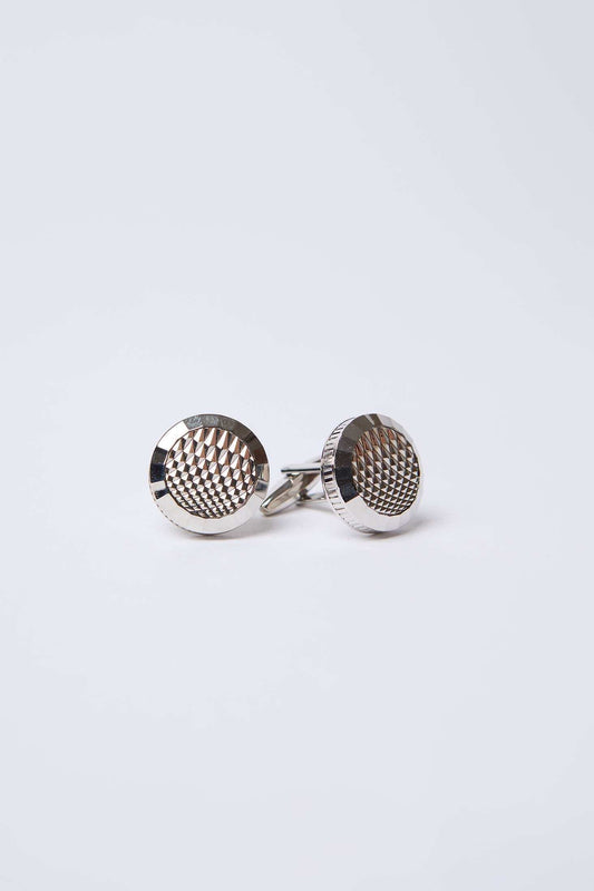 Silver round cufflinks with textured geometric pattern on white background