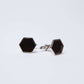 Pair of hexagon black and silver cufflinks on white background