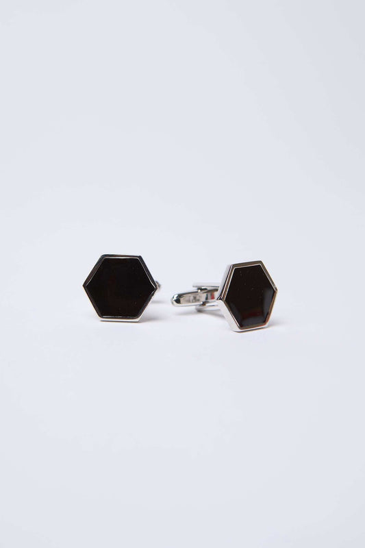 Pair of hexagon black and silver cufflinks on white background