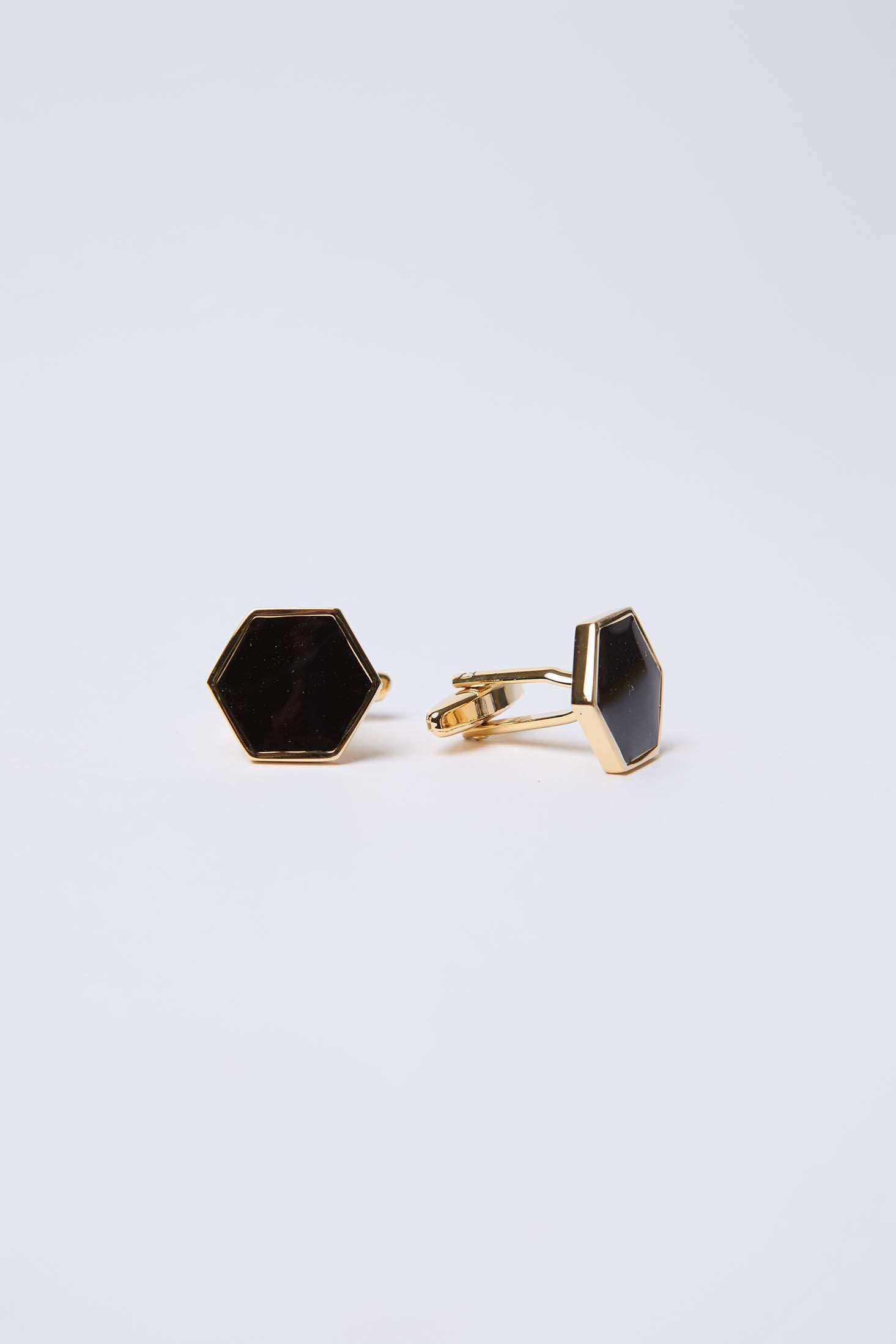 Hexagon black and gold cufflinks on a plain white background