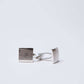 Silver square textured cufflinks on white background, men's accessories