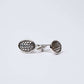 Silver round cufflinks with a geometric lattice pattern on a white background