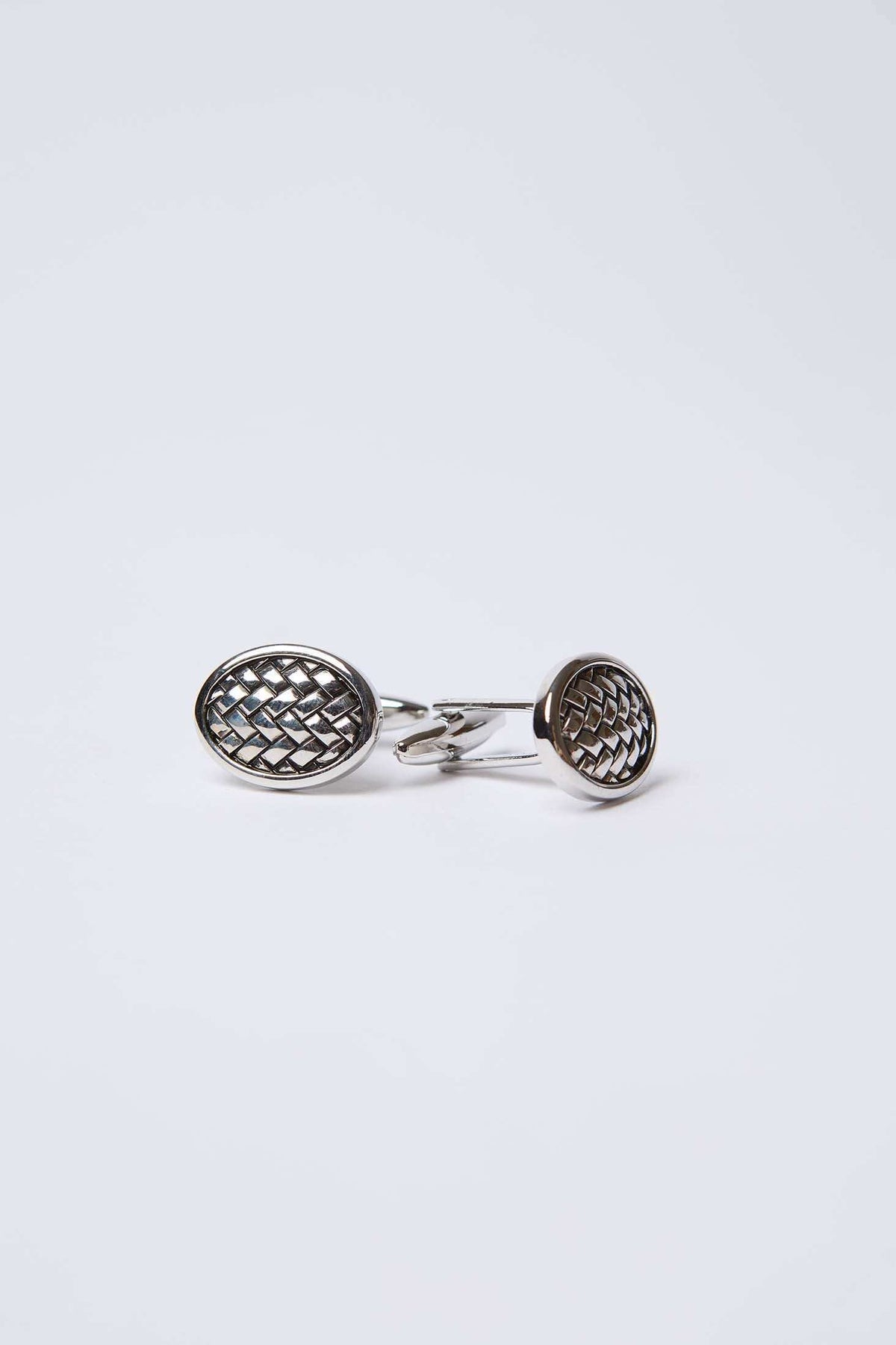 Silver round cufflinks with a geometric lattice pattern on a white background