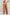 Back view of woman wearing loose-fit camel brown high-waisted wide-leg pants