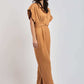 Woman wearing a stylish light brown jumpsuit with short sleeves and belted waist