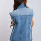 Woman wearing sleeveless denim vest with frayed edges, shown from the back