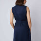 Woman wearing sleeveless navy tunic top with matching pants, back view, minimalist style