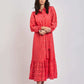Woman modeling pink embroidered long-sleeve dress from Dalydress, white background