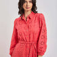 Woman wearing coral eyelet embroidered dress with belt from Dalydress collection