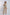 Woman wearing sleeveless embroidered vest with floral pattern over beige casual outfit