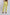 Woman wearing high-waisted yellow pants and brown heels, back view, casual fashion
