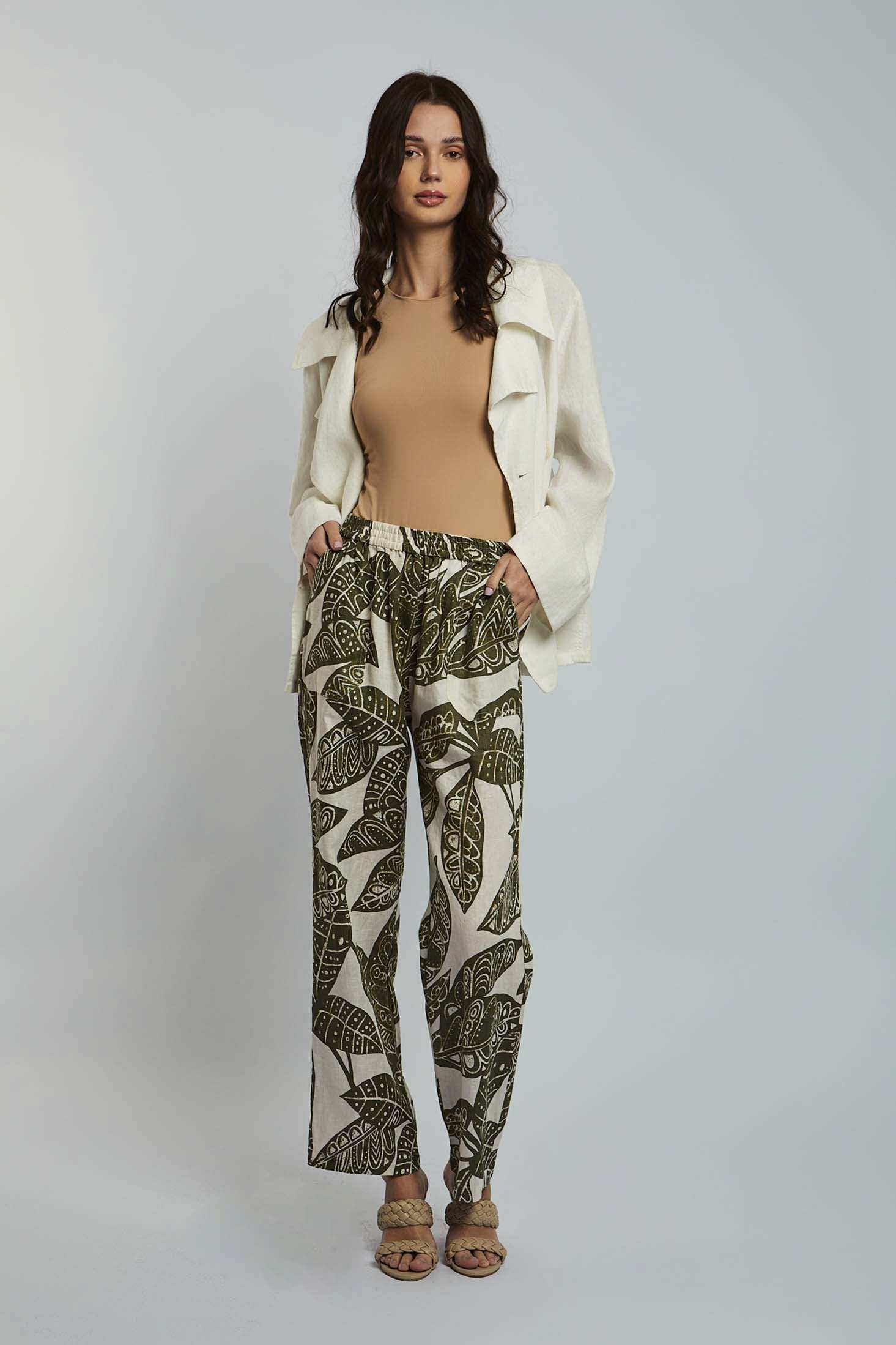 Dalydress woman wearing beige top, white jacket, and leaf print pants, fashion lookbook