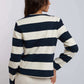 Woman wearing Dalydress navy and white striped long-sleeve top, back view