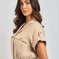 Woman wearing a beige short-sleeve belted shirt dress with button details