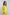 Woman wearing a yellow embroidered linen jacket and matching pants, casual outfit