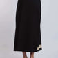Black women's midi skirt with beige embroidery at hem, styled with nude heeled sandals