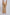 Women's patterned wide-leg pants in tan with pink and orange floral motifs, back view