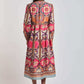 Woman wearing a long-sleeve, colorful floral boho midi dress, shown from the back