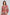 Woman wearing a colorful bohemian long-sleeve dress with vibrant geometric and floral patterns.