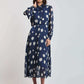 Woman wearing Dalydress blue polka dot pleated midi dress with long sleeves