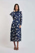 Woman wearing Dalydress blue polka dot pleated midi dress with long sleeves