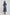Woman wearing Dalydress navy blue polka dot midi dress with long sleeves and pleated skirt
