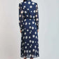 Woman wearing navy blue polka dot pleated midi dress from Dalydress, back view