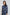 Woman wearing a Dalydress blue polka dot pleated dress with tie-neck detail