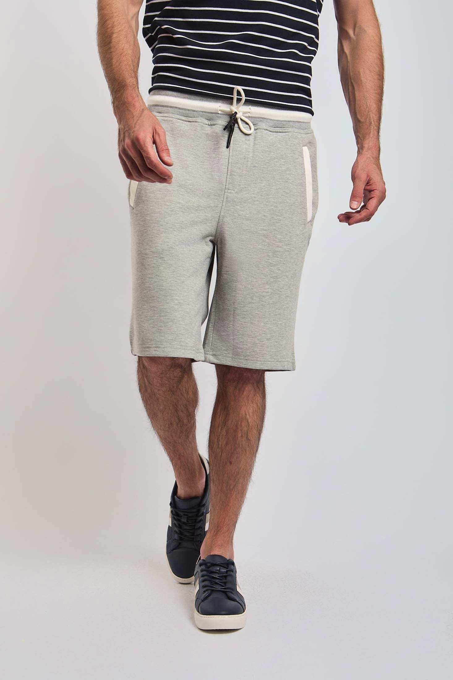 Man wearing Dalydress grey drawstring shorts and striped t-shirt, casual men's fashion