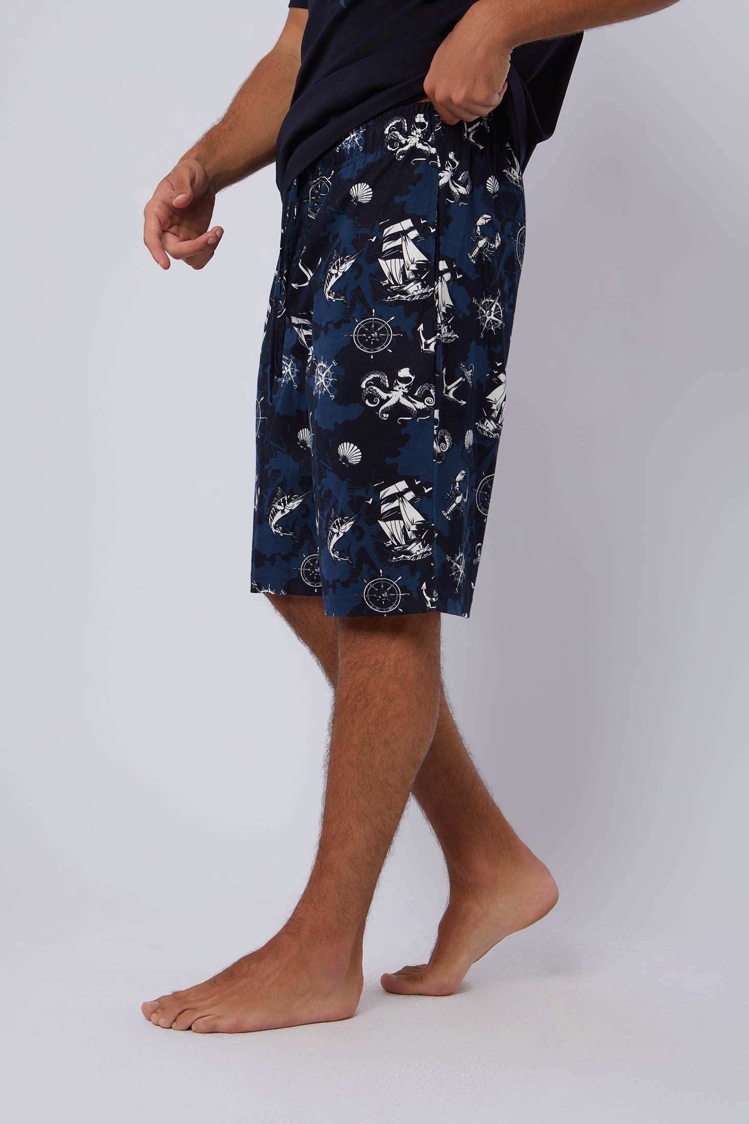 Dalydress men's navy shorts with nautical print, casual wear, model standing indoor