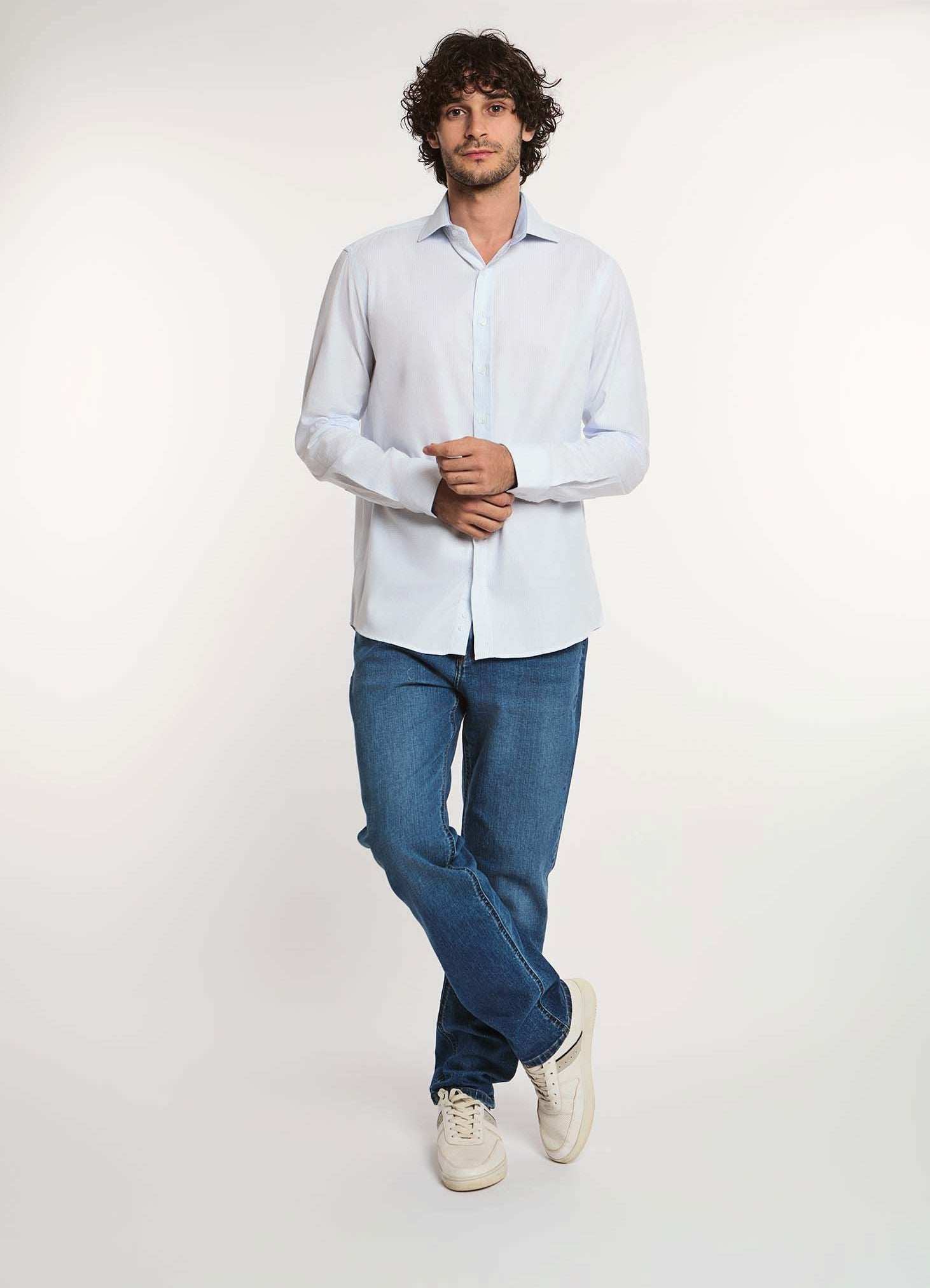 Man wearing white dress shirt and blue jeans from Dalydress, casual men's fashion
