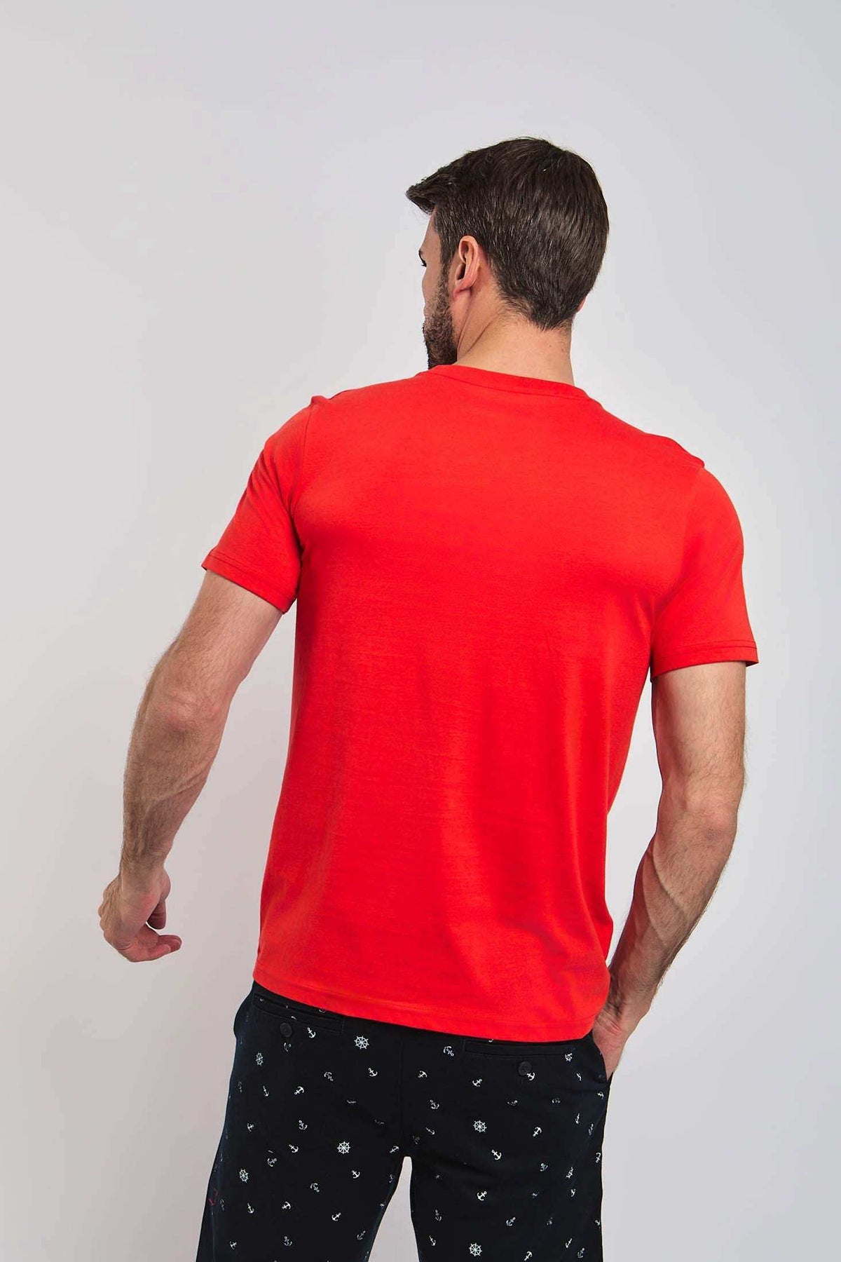 Dalydress men's red short sleeve t-shirt, back view, with navy patterned trousers