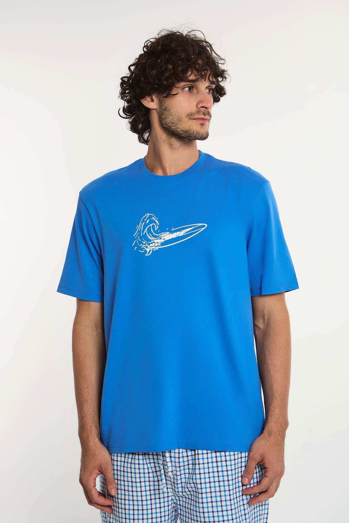 Dalydress men's blue t-shirt with wave and surfboard print, paired with plaid shorts