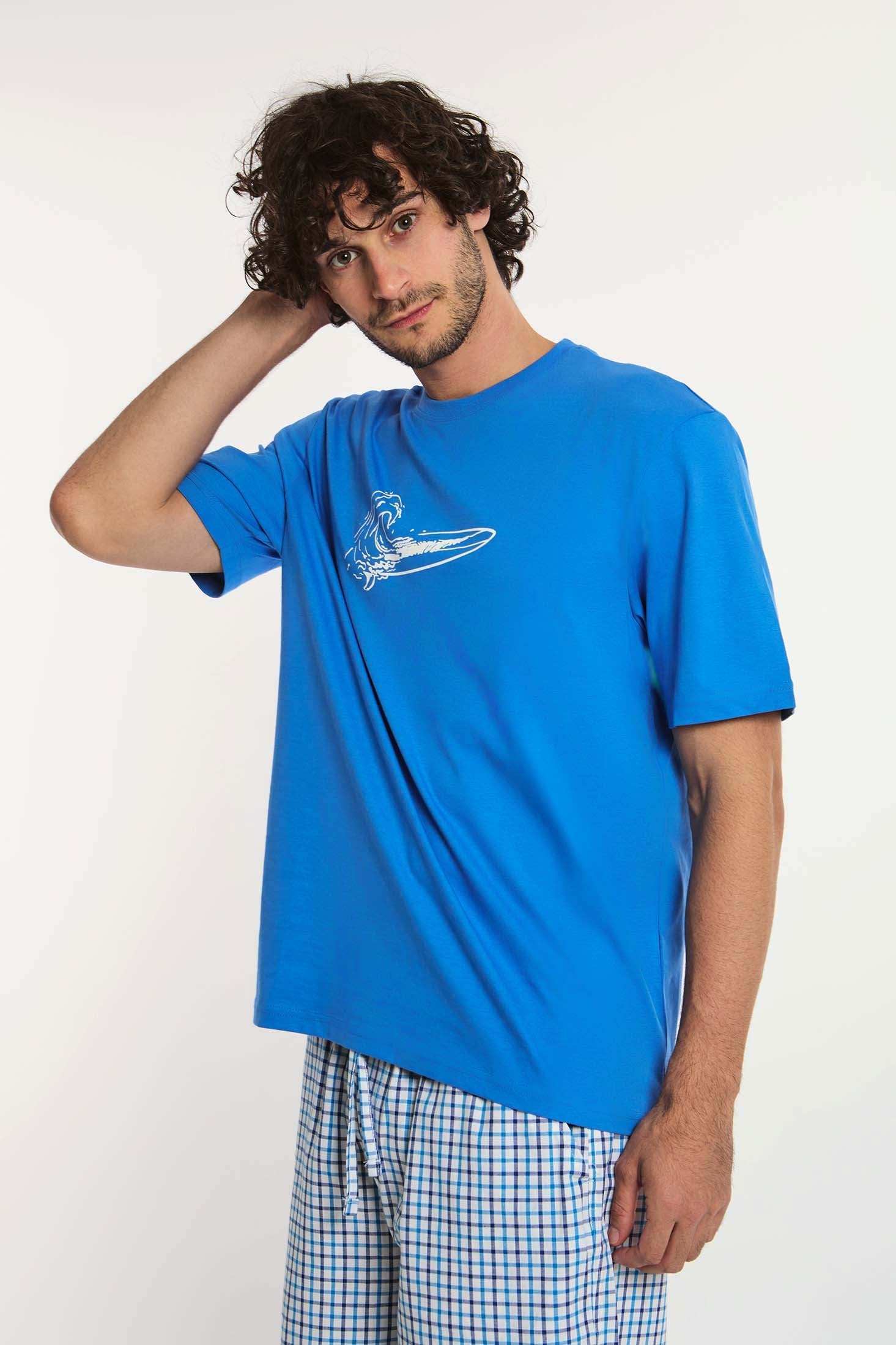 Dalydress men's casual look, blue surfboard tee and checkered shorts, studio background