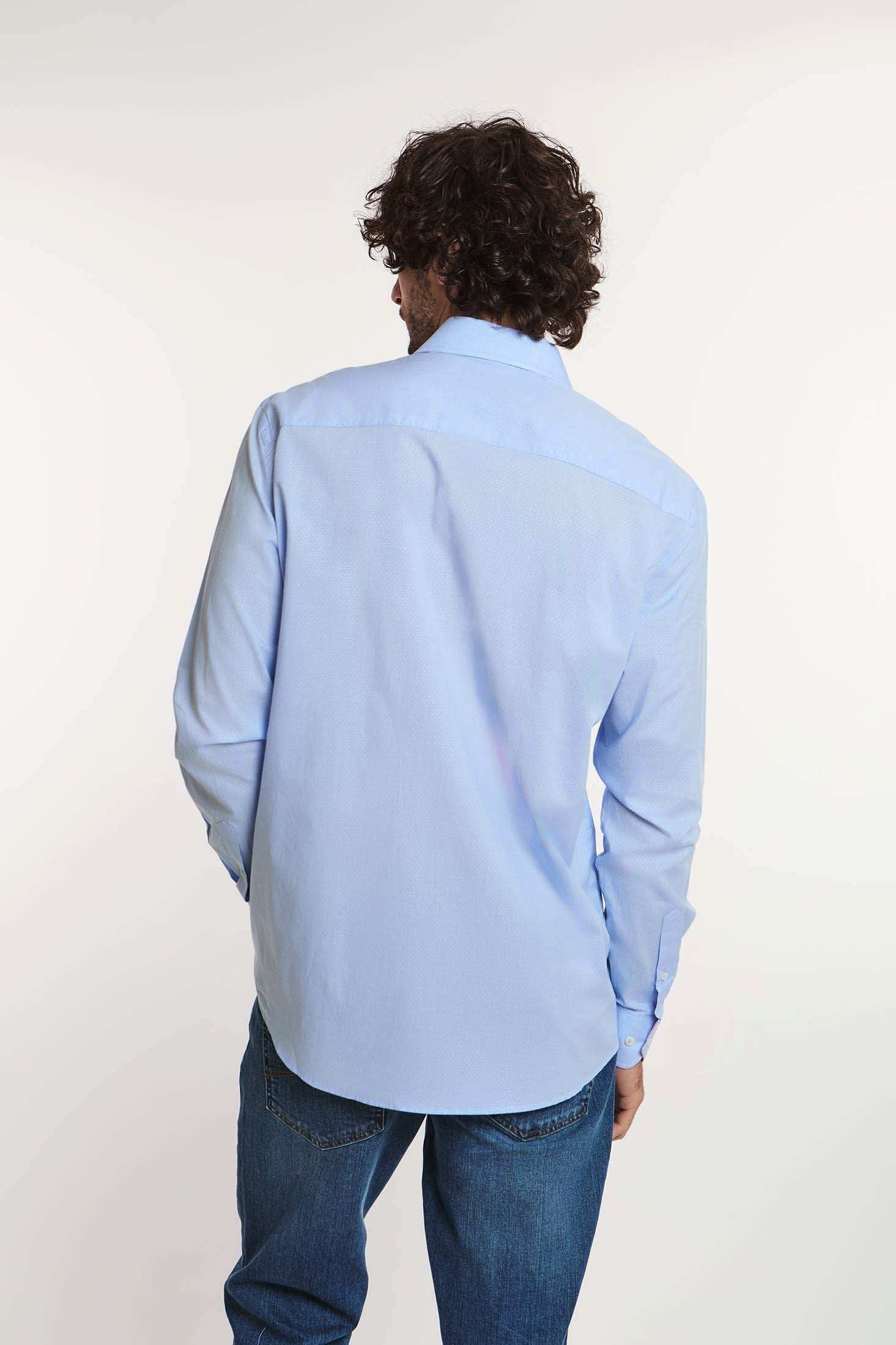 Man wearing light blue Dalydress men's shirt and blue jeans, back view, on white background
