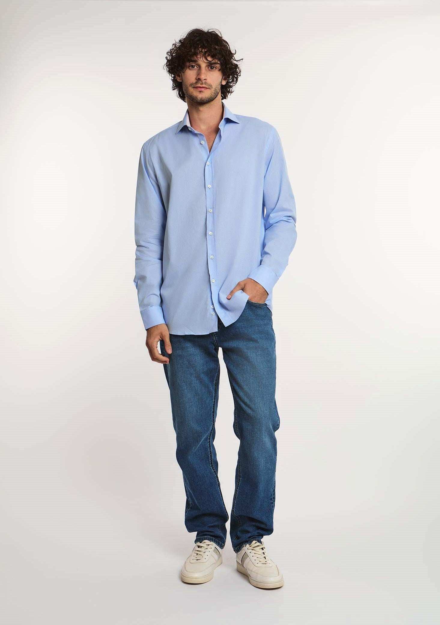 Man wearing light blue dress shirt, blue jeans, and white sneakers, Dalydress men's fashion