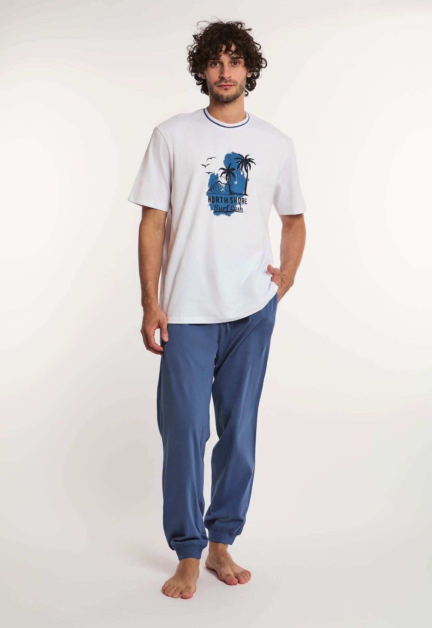 Dalydress men's casual wear with white printed t-shirt and blue pants, studio setting