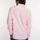 Man wearing Dalydress men's pink button-up shirt and blue jeans, back view