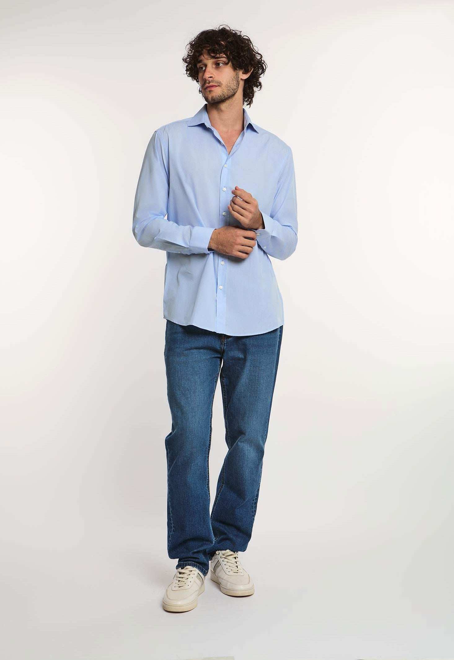 Dalydress men's casual blue button-down shirt with jeans and sneakers, studio background