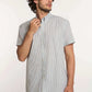 Man wearing Dalydress men's short sleeve striped button-down shirt with beige pants