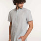 Man wearing Dalydress short-sleeve striped button-up shirt and beige pants, front view
