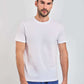 Dalydress men's white t-shirt with short sleeves, paired with blue pants, studio background