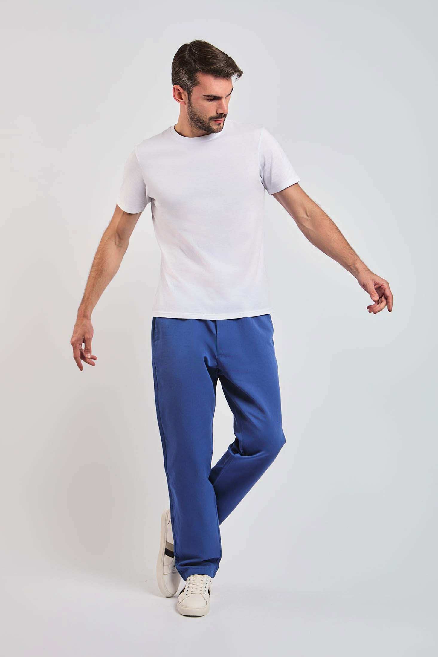 Dalydress men's white t-shirt and blue pants casual outfit, model standing, studio background